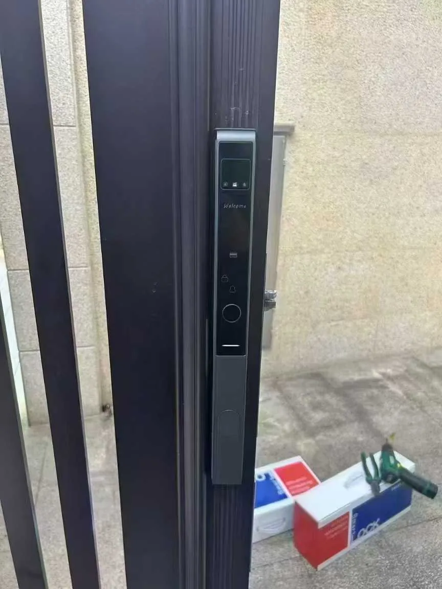 CaremLock fully automatic smart lock installed on a dark entrance gate