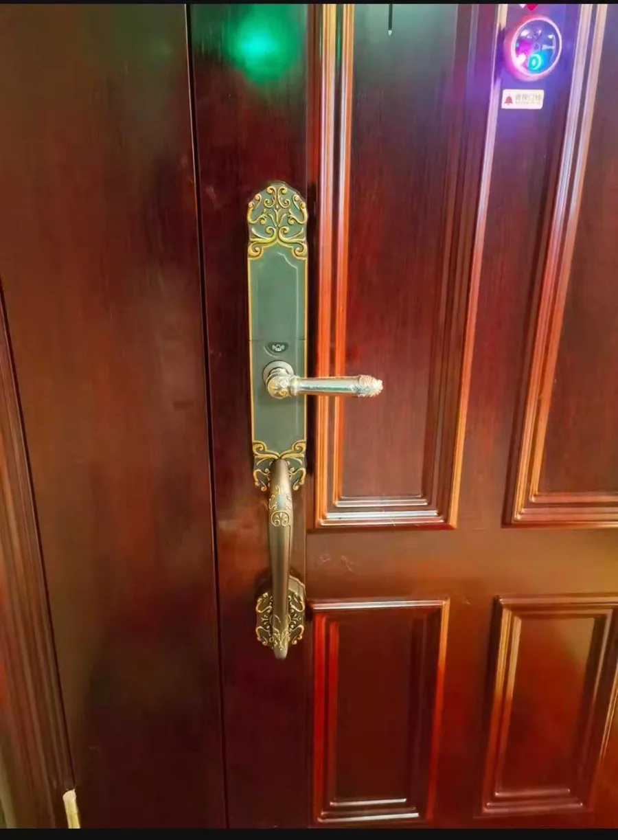 CaremLock smart lock installed on a wooden entry door