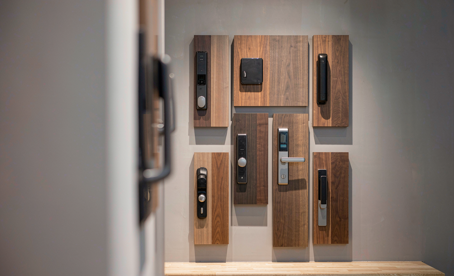 Range of smart lock models on a showroom display wall — editorial product illustration
