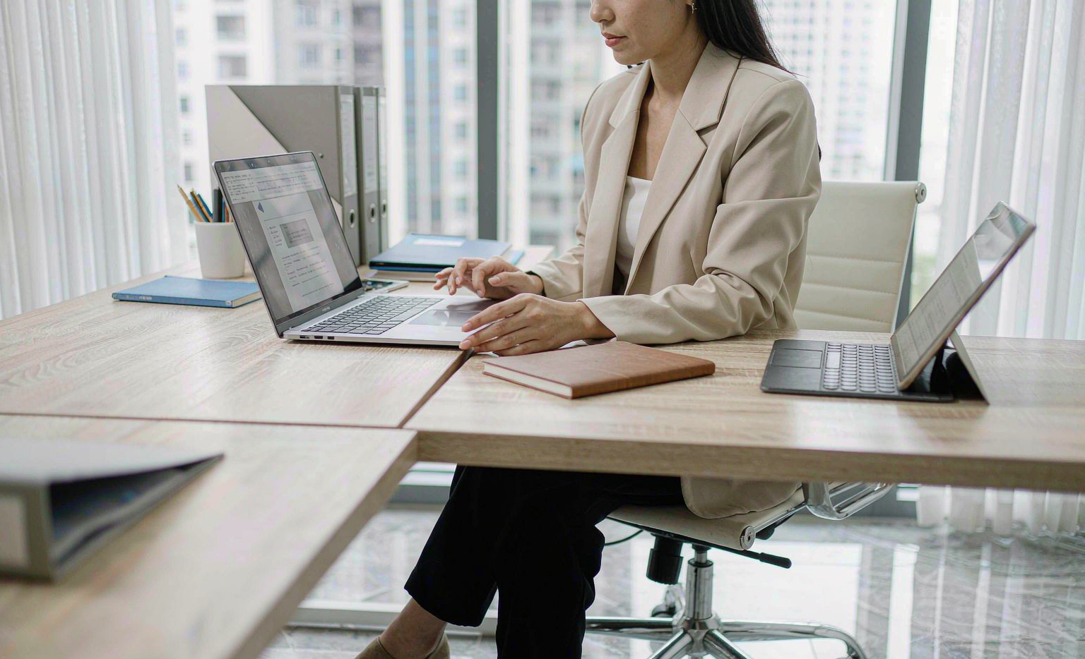 Buyer reviewing supplier qualification documents on a laptop — editorial illustration